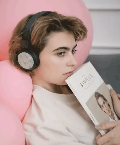 Student reading with sleek protective headphone wrap